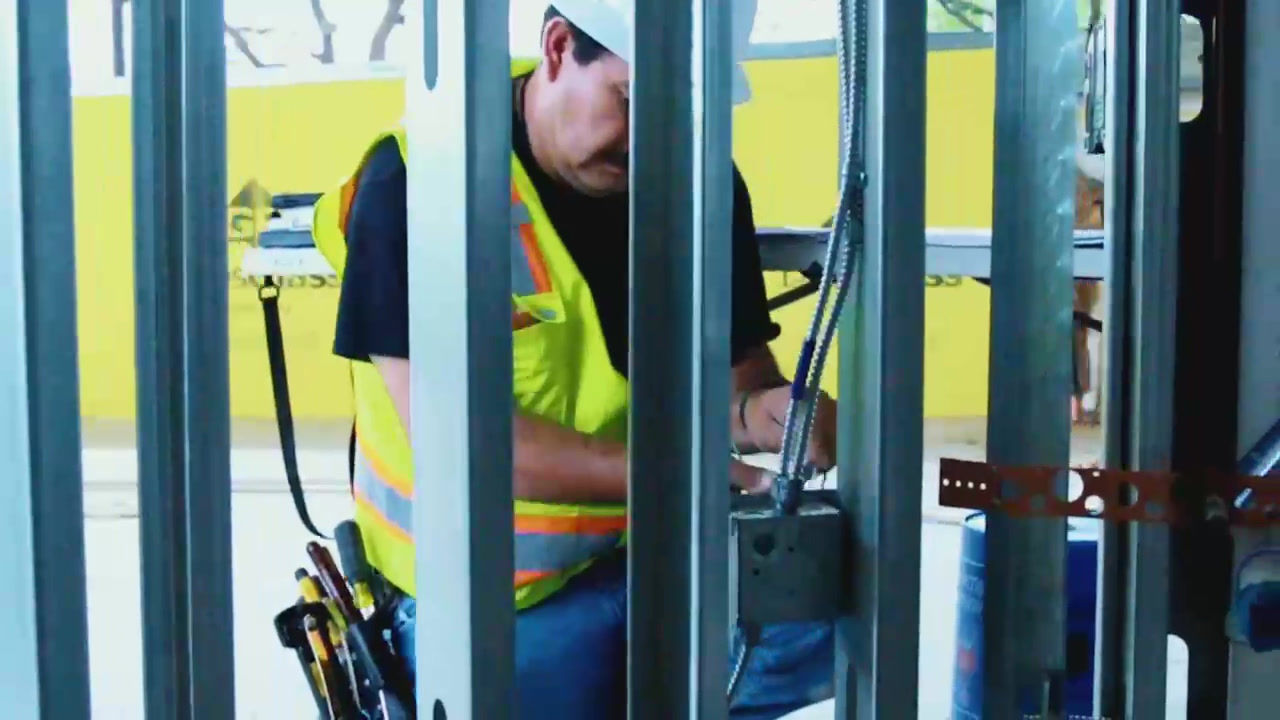 Wired Generations electrician working at a commercial job site, installing electrical wiring in metal stud framing